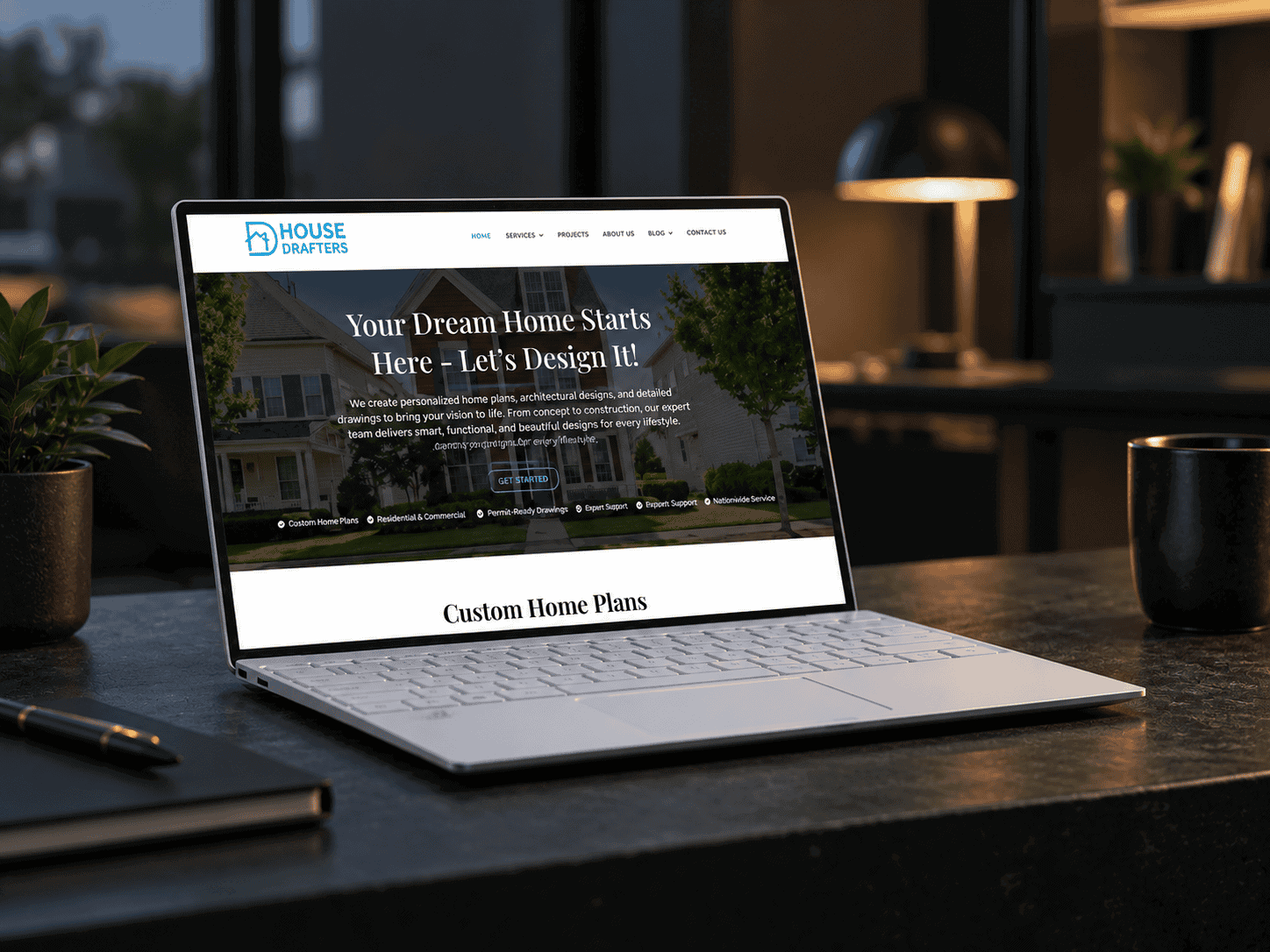 Laptop displaying a home design website on a modern desk setup.